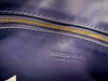 Bottega Veneta Hop Small Duke Navy Intrecciato — interior view: close-up with the embossed "Bottega Veneta, Made in Italy" stamp beside the gold zipper.