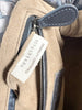 Bottega Veneta Lauren 1980 Clutch Black Intrecciato — detail: close-up of the interior zip pocket with the 'Originality Certified' authenticity tag.