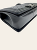 Chanel Boy Medium Black Lambskin — detail: angled base/corner view showing the smooth leather sides and base seam.
