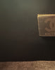 Chanel Boy Medium Black Lambskin — detail: close-up of the Chanel authenticity microchip inside the bag.