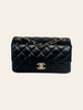 Chanel Mini Rectangular Flap Black Lambskin — front view of the Chanel Mini Rectangular Flap in black quilted lambskin with a gold CC turn-lock and chain strap.
