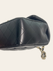Chanel Mini Rectangular Flap Black Lambskin — detail: close-up of the opposite quilted side panel with chain strap visible.