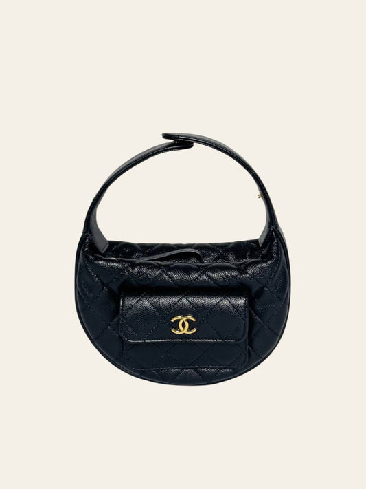Chanel Polly Pocket Hobo Black Caviar — front view of the Chanel Polly Pocket Hobo in black caviar leather, with its signature exterior flap pocket and gold CC clasp.