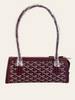 Goyard Bonbonnière Burgundy Goyardine — front view of the burgundy Bonbonnière, dual straps still wrapped in protective plastic, off white background.