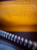 Goyard Bonbonnière Burgundy Goyardine — detail: extreme close-up of the embossed "Goyard Paris, Made in France" stamp on the interior leather, zipper visible.