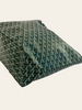 Goyard Saint Louis PM Green Goyardine — overhead/angled view of the green Goyardine chevron tote lying flat, still wrapped in protective plastic.