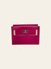Hermès Kelly Pocket Compact Wallet Rose Pourpre Epsom — front view with the original protective felt guards still on the edges, shown new with tags.