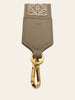 Loewe Anagram Strap in Jacquard and Calfskin Sand Gold — detail: close-up of the leather tab with its embossed serial number.